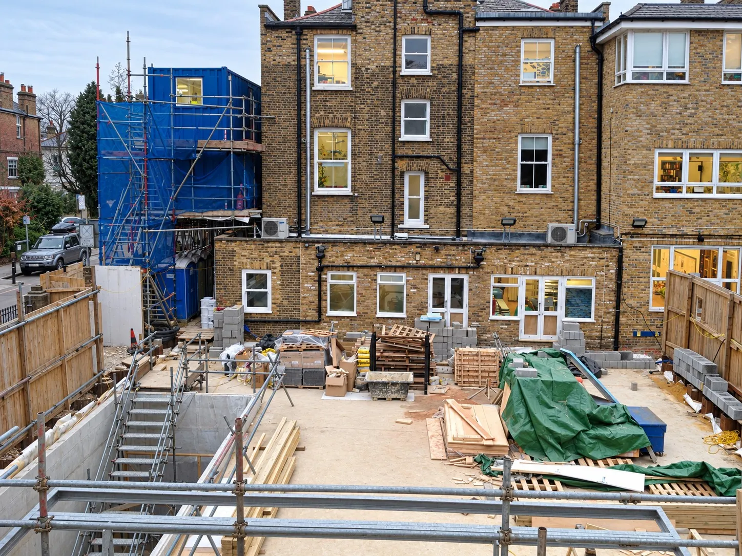 Ground slab poured on a London new-build site, with materials stacked ready for the frame