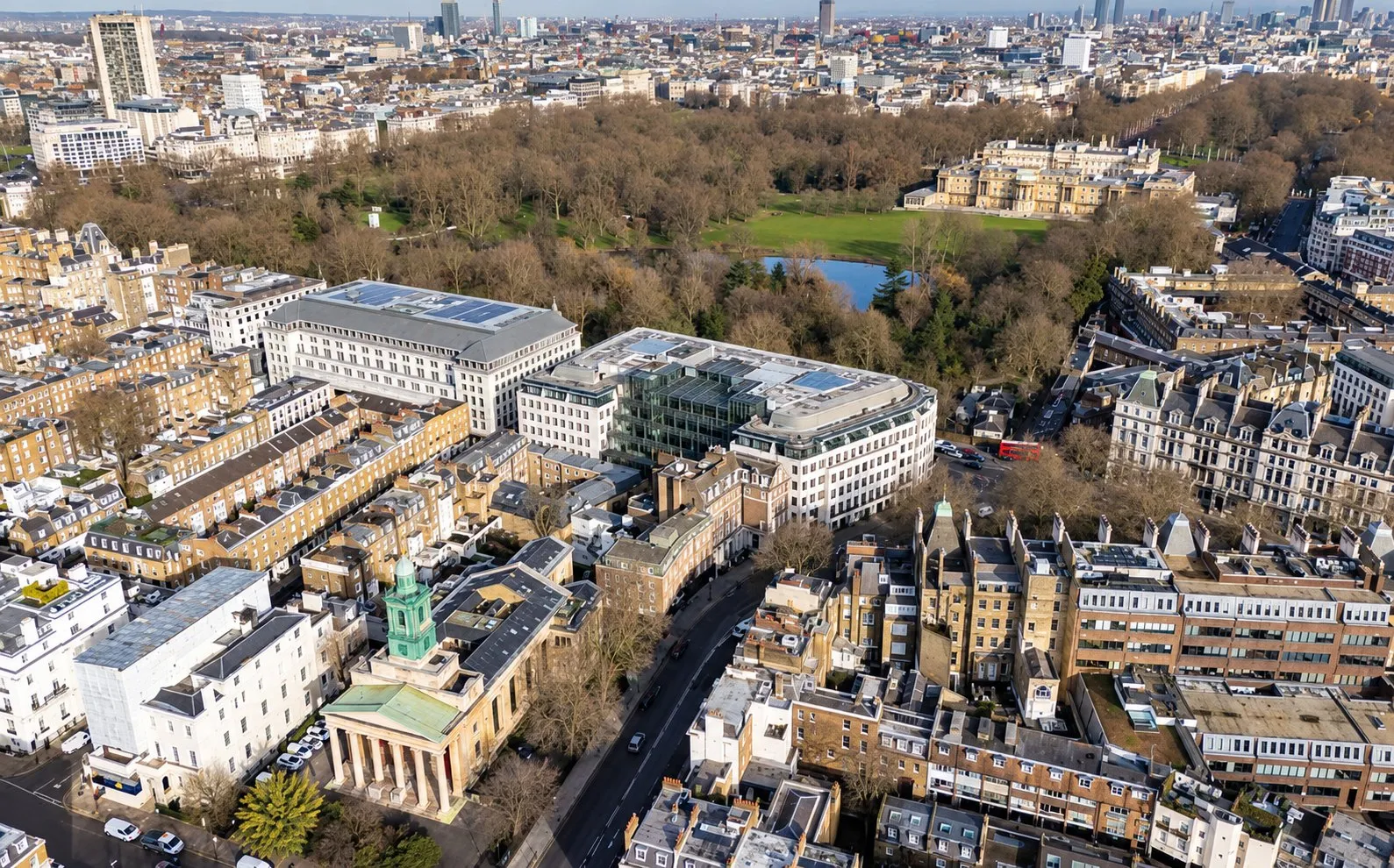 Aerial view over central London terraces, offices and a royal park