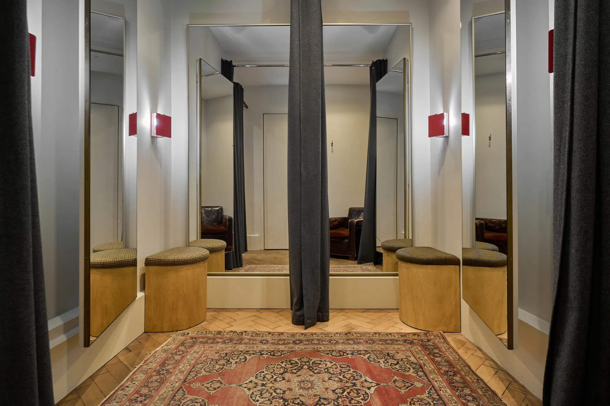 Fitting rooms with mirrors and red wall lights