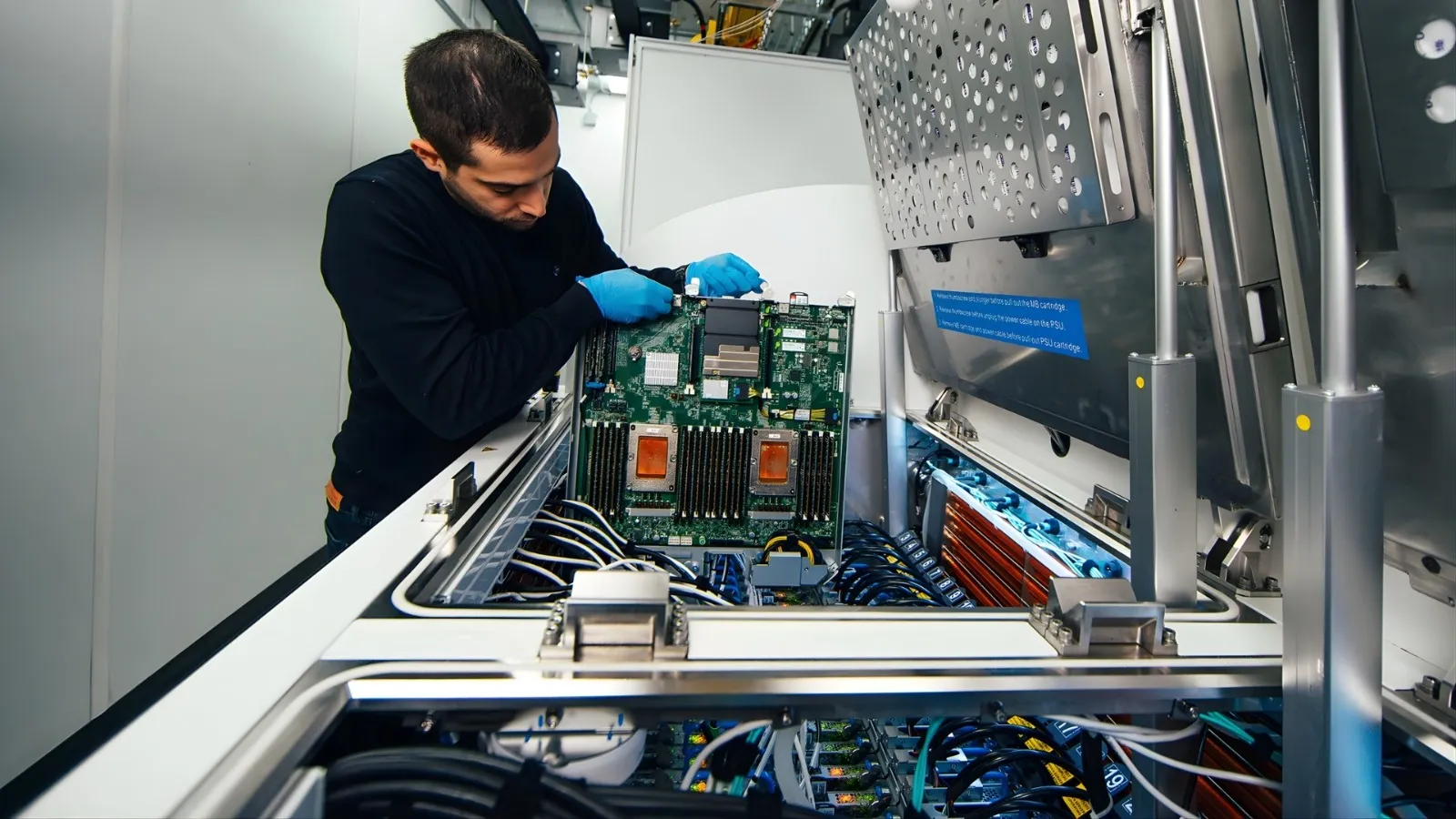 Engineer working on a server board in a data centre