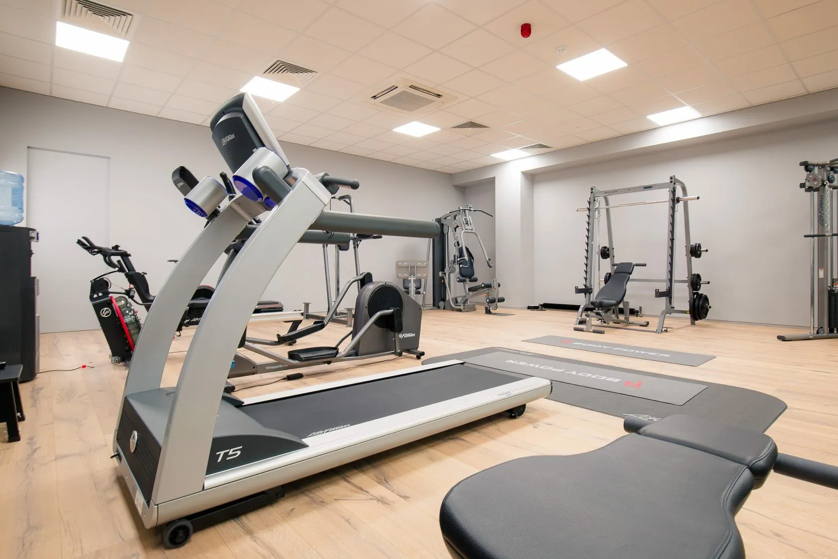 Finished gym with treadmills, bikes and weight stations on a timber floor at Banbury, fitted out by Craftex