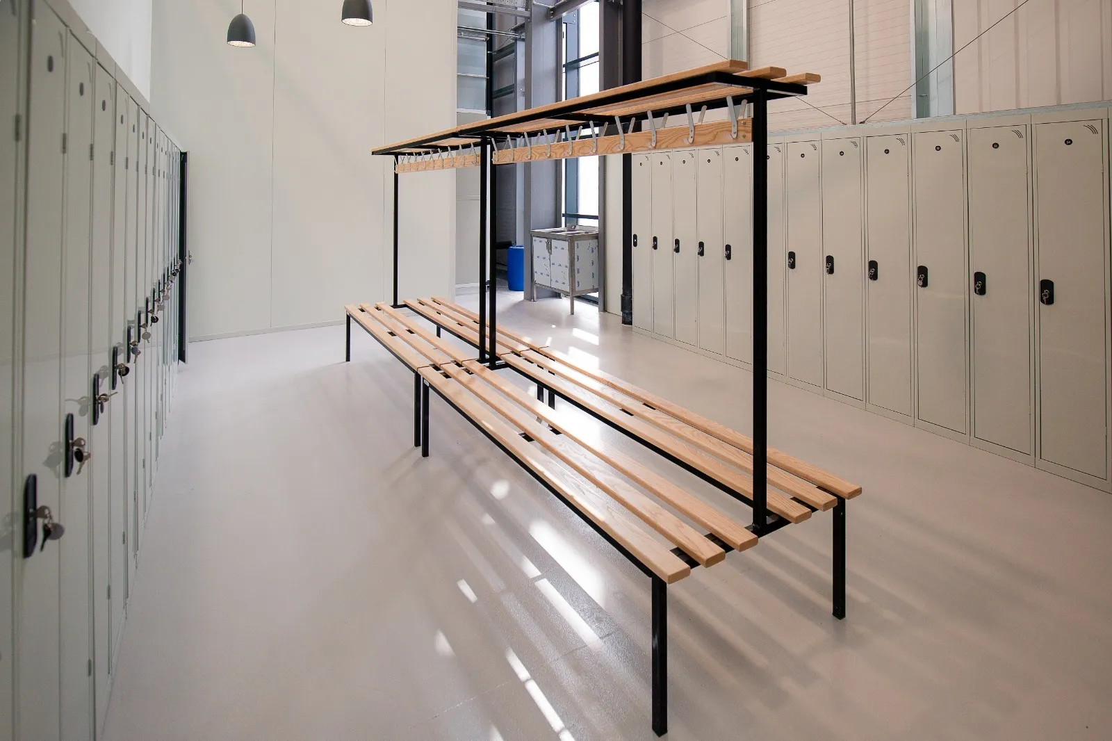 New changing room with grey lockers and a long timber bench and coat rail inside the Banbury warehouse