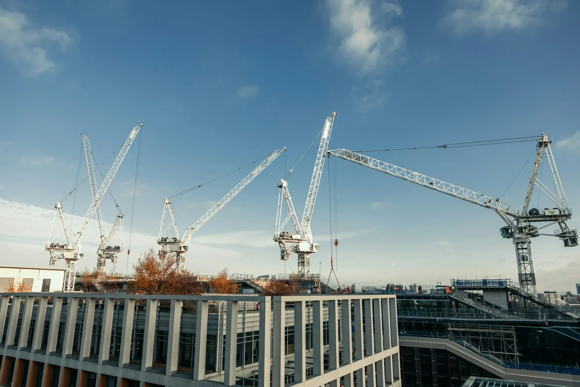Tower cranes over a large London development site on a clear autumn day