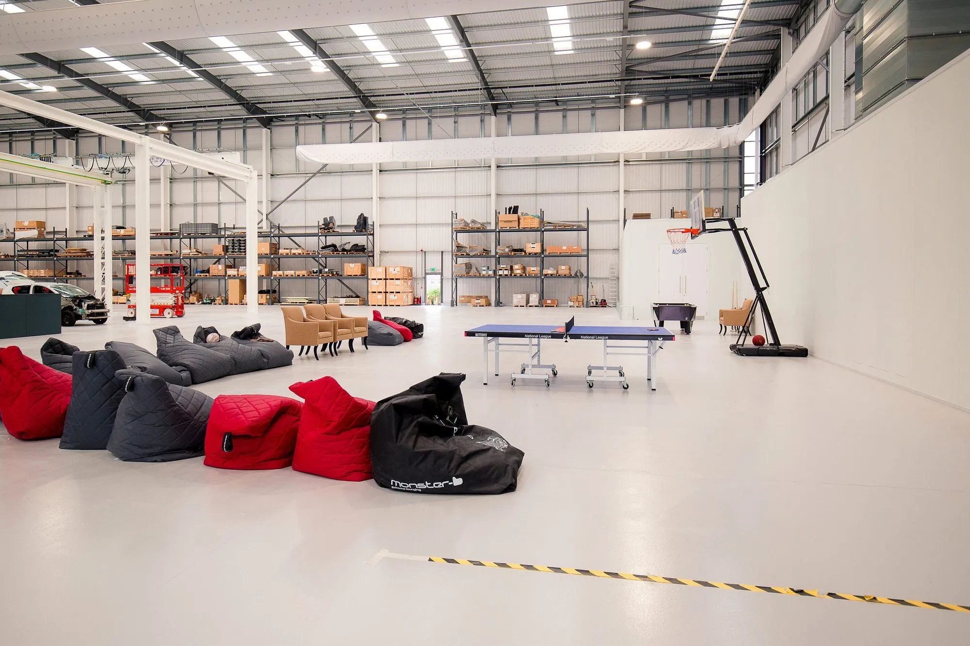 Staff zone with bean bags and a table-tennis table on the new resin floor of the Banbury warehouse